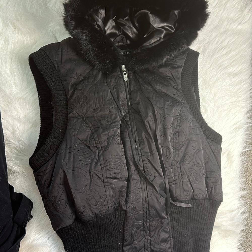 Women’s black Bebe vest with fur hood. Excellent condition.